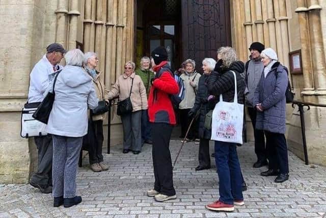 A walking tour group outside Arundel Cathedral