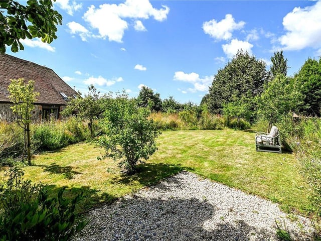 The property comes with access to wild gardens and a pond.