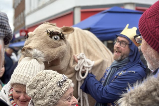 A cheeky camel makes a grab for one unlucky resident's hat.