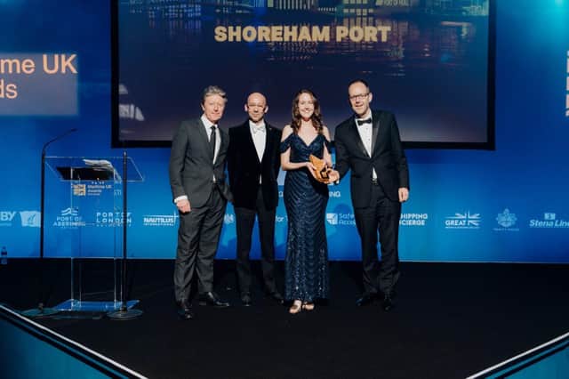 Nicky Brown (middle right) and Tom Willis (right) collecting Maritime UK Award