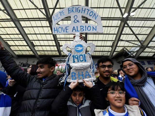Brighton's supporters celebrate with a mock trophy at the end of the English FA Cup quarter-final football match between Brighton & Hove Albion and Grimsby Town at the Amex stadium in Brighton, on the south coast of England on March 19, 2023 (Photo by GLYN KIRK/AFP via Getty Images)