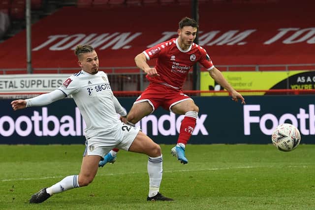 Crawley Town's Nick Tsaroulla (right) shoots past Leeds United's Kalvin Phillips to open the scoring during the Reds' famous FA Cup third round win over the Whites on January 10, 2021. Picture by GLYN KIRK/AFP via Getty Images