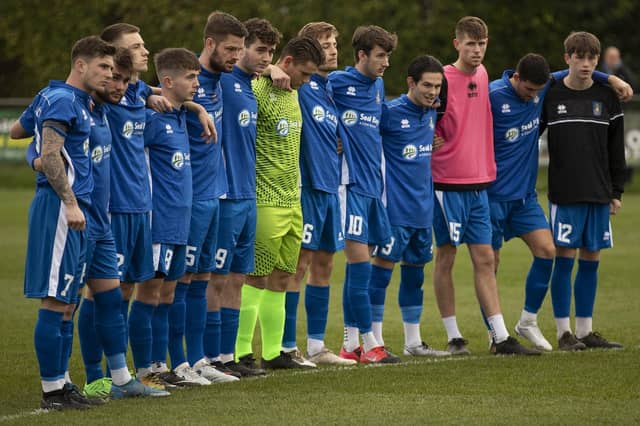 Selsey and Worthing Players have a minute's silence before their match for Club member Bob Pearce