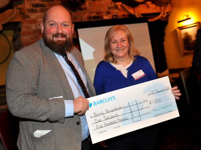 Charity champion Richard Curtis presents a cheque for £1,500 to Being Neighbourly in East Grinstead