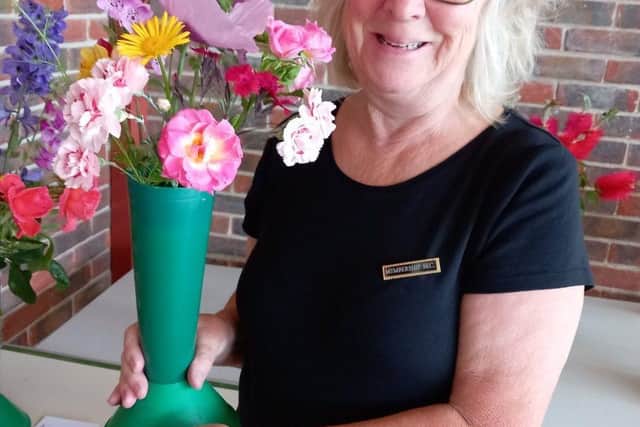 Linda with her winning vase of mixed flowers