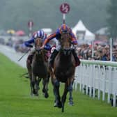 CHICHESTER, ENGLAND - AUGUST 02: Ryan Moore riding Paddington (orange/blue) win The Qatar Sussex Stakes at Goodwood Racecourse on August 02, 2023 in Chichester, England. (Photo by Alan Crowhurst/Getty Images):Images from a murky second day at Glorious Goodwood by Alan Crowhurst of Getty and Clive Bennett