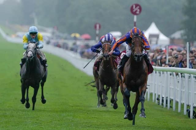 CHICHESTER, ENGLAND - AUGUST 02: Ryan Moore riding Paddington (orange/blue) win The Qatar Sussex Stakes at Goodwood Racecourse on August 02, 2023 in Chichester, England. (Photo by Alan Crowhurst/Getty Images):Images from a murky second day at Glorious Goodwood by Alan Crowhurst of Getty and Clive Bennett