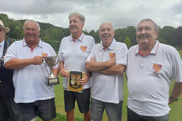 Charles Wright, Steve Judd, Ken Ferguson and Michael Knights are presented with their trophy and pennant.