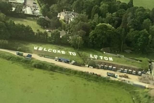 The 'Welcome to Luton' sign near Gatwick Airport was photographed by Abbey Desmond from a plane on Saturday morning, May 21