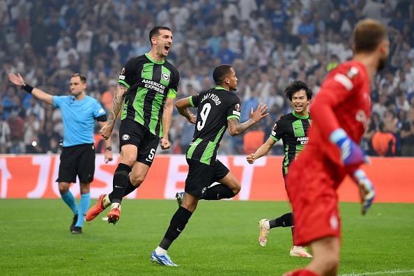 Joao Pedro of Brighton & Hove Albion celebrates with teammates Lewis Dunk and Kaoru Mitoma
