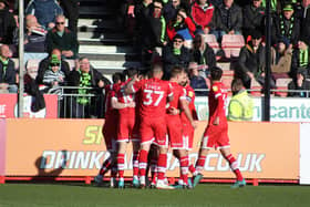 Crawley Town players celebrate in front of Forest Green Rovers fans