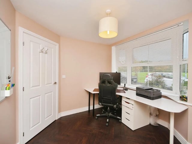 The entrance hall leads to an office