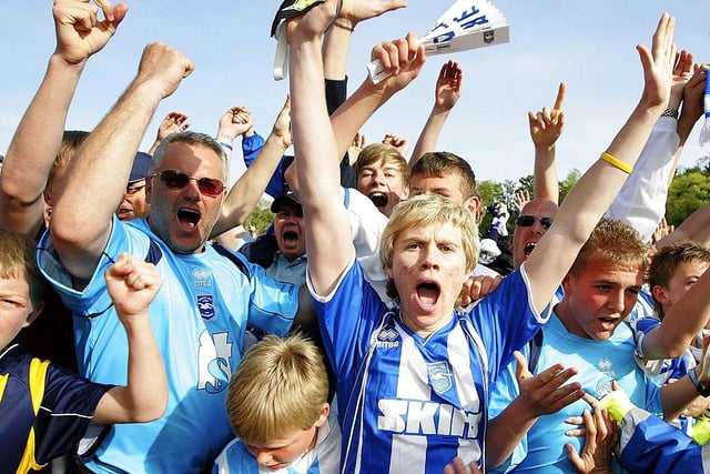 Supporters of Brighton & Hove Albion celebrate after winning the game against Stockport which prevented the team from relegation, during the Coca Cola League One match between Brighton & Hove Albion and Stockport County at Withdean Stadium on May 02, 2009.
