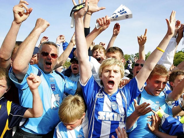 Supporters of Brighton & Hove Albion celebrate after winning the game against Stockport which prevented the team from relegation, during the Coca Cola League One match between Brighton & Hove Albion and Stockport County at Withdean Stadium on May 02, 2009.