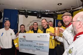 Sussex sea shanty favourites The Wellington Wailers presented three cheques to the RNLI during a packed performance at their home base in Shoreham