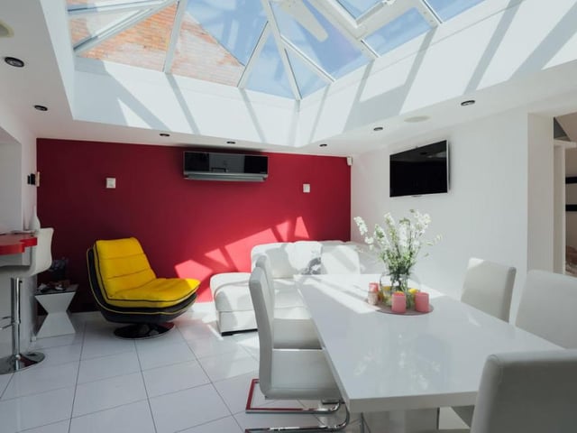 The sun shines on the dining area at the Southwell property. The room has air conditioning and a wall-mounted TV, among other features.