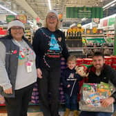 Four-year-old Harrison O’Neill and his dad Andy collecting the hamper gift from Alison Whitburn at Morrisons in Littlehampton