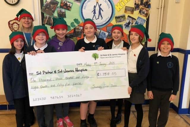 Pupils from Southway Junior School presented St Peter & St James Hospice with a cheque for £1,358 after their Elf Run.