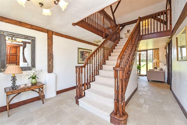 An elegant wooden staircase leads up to the rest of the property.