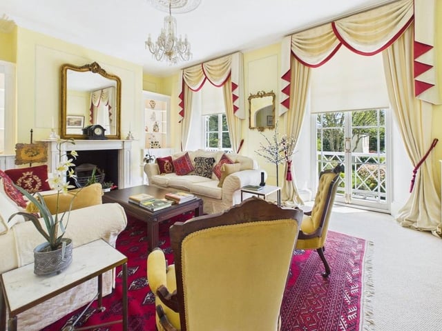 The first-floor reception room is a particular highlight, with French doors to a full-width balcony