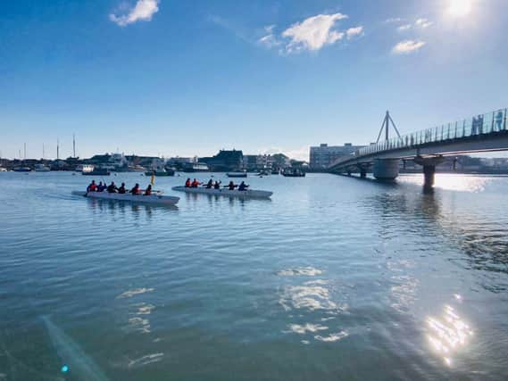 Outrigger canoes line up to to race in Shoreham-by-sea