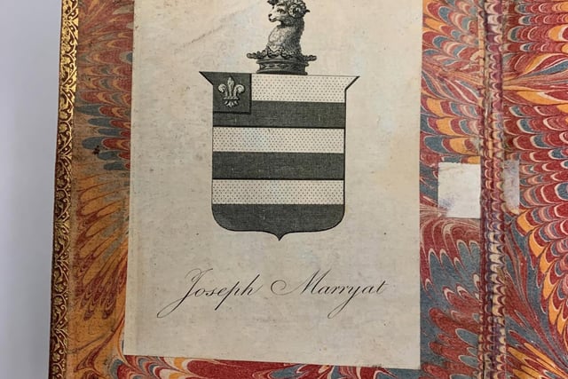 A bookplate for Joseph Marryat, with an accompanying Coat of Arms, adorns the inside cover.