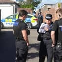 A police guard on Chester Avenue and Brighton Road, in Lancing, with an alleyway sealed off to allow access for search teams