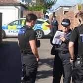 A police guard on Chester Avenue and Brighton Road, in Lancing, with an alleyway sealed off to allow access for search teams