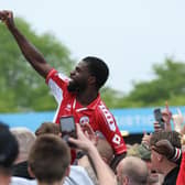 Crawley Town striker Tobi Adeyemo is lifted by fans after the 0-0 draw with Salford City | Picture: Natalie Mayhew/Butterfly Football