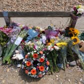 Locals have laid flowers at the scene of the incident in memory of the family. Photo: Eddie Mitchell