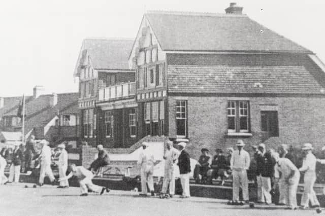 The old clubhouse in 1951. Clarrie Woodhouse has just bowled a wood with his characteristic full stretch delivery.