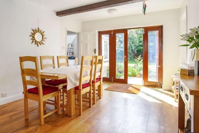 The spacious dual-aspect open plan kitchen/dining room has French doors out to the garden