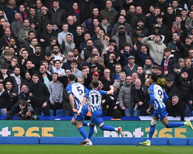 Lewis Dunk of Brighton celebrates in front of Crystal Palace supporters after opening the scoring during the Premier League match between Brighton & Hove Albion and Crystal Palace at American Express Community Stadium on February 03, 2024 in Brighton, England. (Photo by Mike Hewitt/Getty Images)
