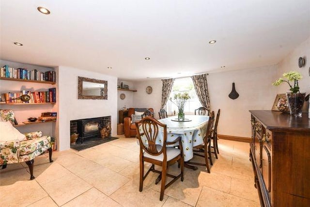 To the lower ground floor, there is a Hallway and doors through to the Dining Room with window to the front and large impressive woodburner.