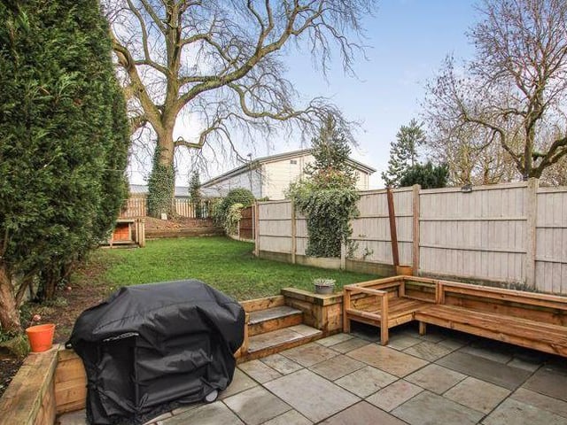 The lengthy, enclosed back garden is very pleasing on the eye. As well as a lawned area, there are trees and shrubs, plus a patio area with seating.