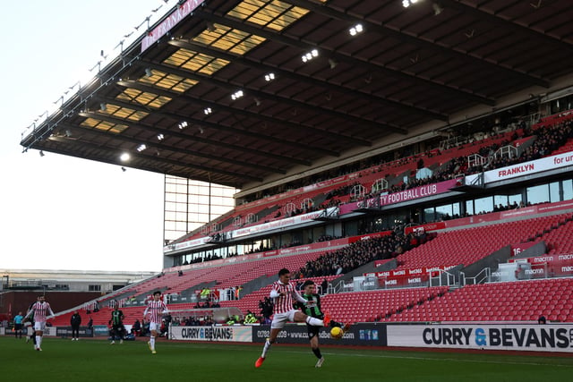 Players compete for the ball against a view of empty seats during the English FA Cup third round football match between Stoke City and Brighton and Hove Albion at the bet365 Stadium, in Stoke on Trent, central England, on January 6, 2024. (Photo by Darren Staples/AFP via Getty Images)