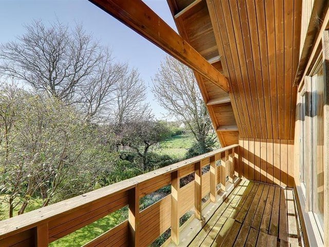 The master bedroom has a private west-facing balcony