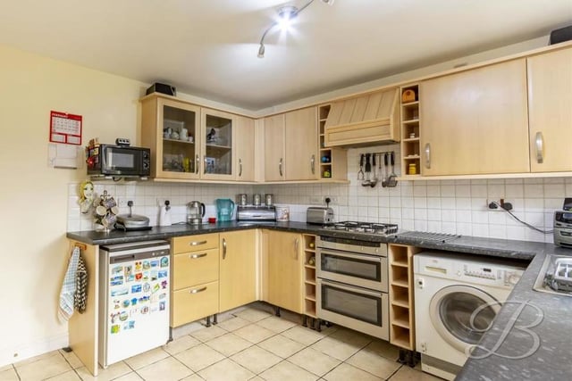 The kitchen is a good size and comes complete with matching cabinets, a work surface, integrated double oven, gas hobs, tiled splashback and extractor fan. There is also space and plumbing for a washing machine.