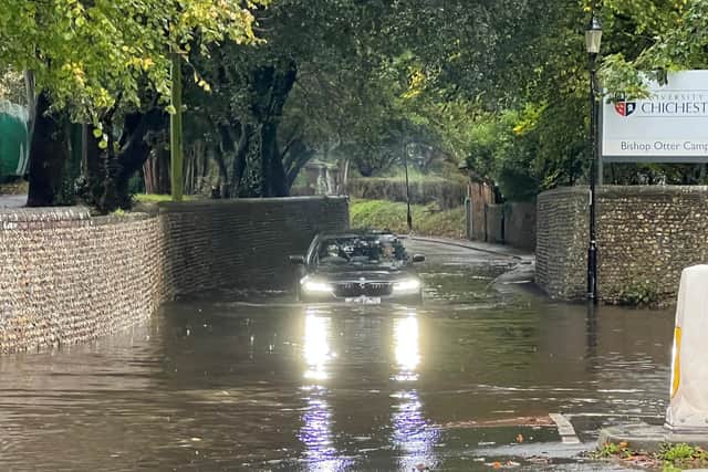 Photographer Eddie Mitchell captured the moment a car got submerged in the water in College Lane, Chichester