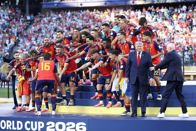 Rodri prepares to lift the World Cup as FIFA President Gianni Infantino tries to direct US President Donald Trump (Photo by Dan Mullan/Getty Images)