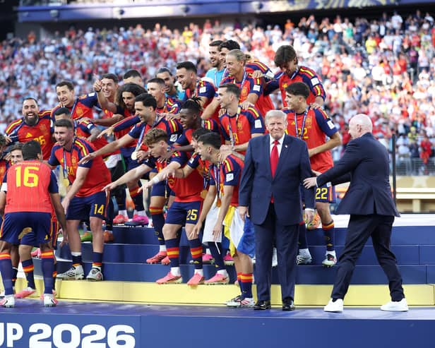 Rodri prepares to lift the World Cup as FIFA President Gianni Infantino tries to direct US President Donald Trump (Photo by Dan Mullan/Getty Images)