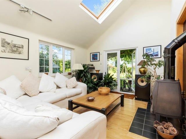 The bright lounge/studio has French doors that open into the garden