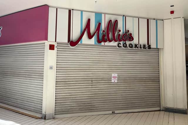 A sign left outside reads: “Please note this store has permanently closed. Visit www.milliescookies.com to see our other store locations.” Photo: Sussex World