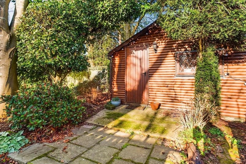 The garden has an insulated log cabin that could be used as a home office, additional bedroom or gym