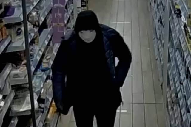 Police investigating a shop robbery in Burgess Hill have released a CCTV image of the suspect. Picture courtesy of Sussex Police