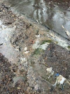 Sewage leaks onto a public path near a children's play area in Billingshurst every time it rains heavily