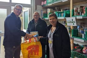 Littlehampton and District Foodbank members Richard, Paul and Clare in the stockroom preparing emergency food parcels