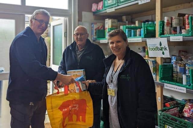 Littlehampton and District Foodbank members Richard, Paul and Clare in the stockroom preparing emergency food parcels