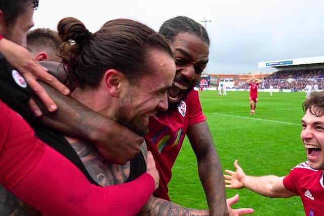 Dom Telford celebrates his goal with teammates at Hartlepool United