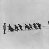 The Antarctica expedition team led by Sir Ernest Henry Shackleton pulling one of their lifeboats across the snow following the loss of the Endurance. Photo by Hulton Archive / Getty Images